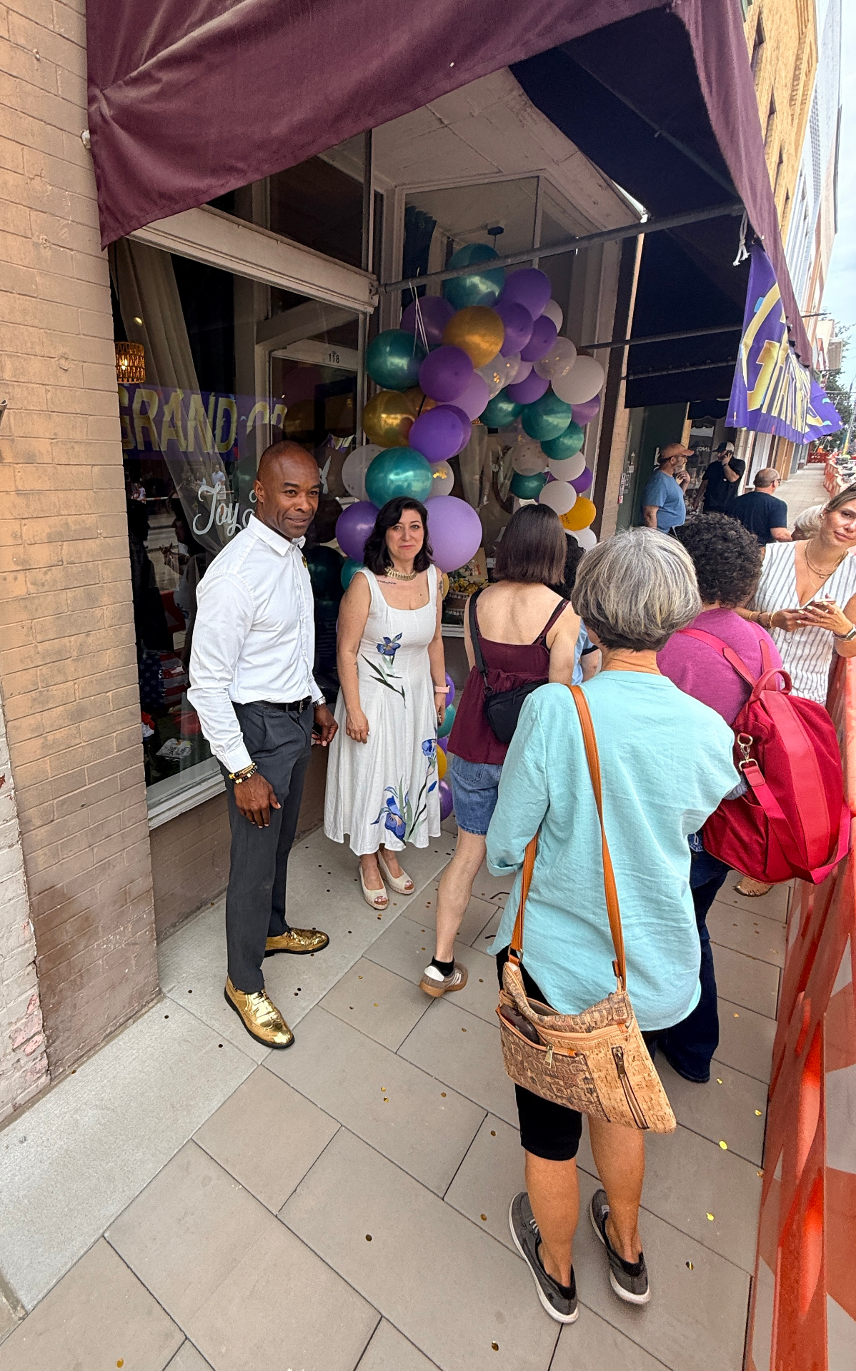 Guests gathered outside the Joyfully House storefront with balloons
